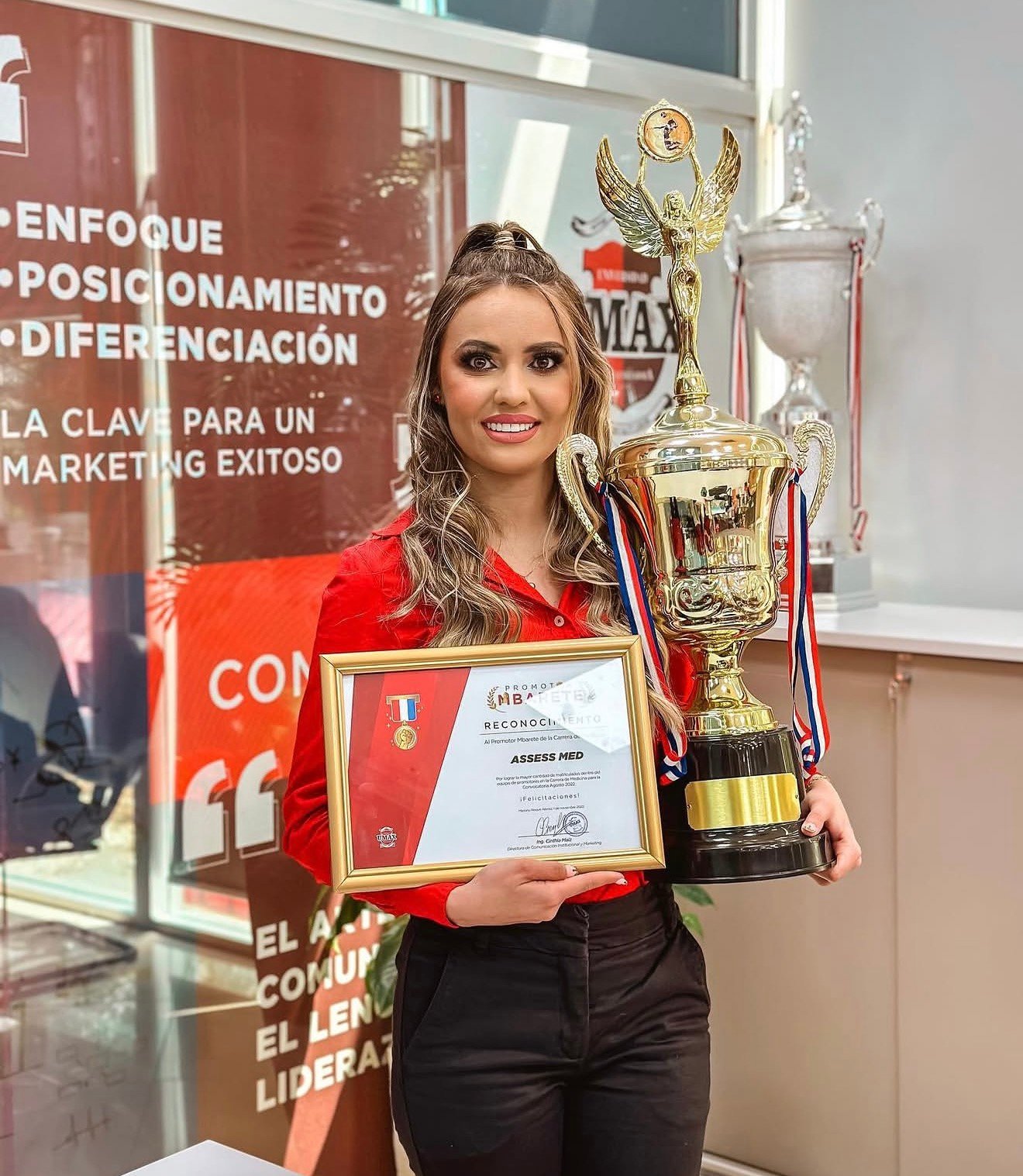 Profissional da ASSESS MED com certificado e troféu
